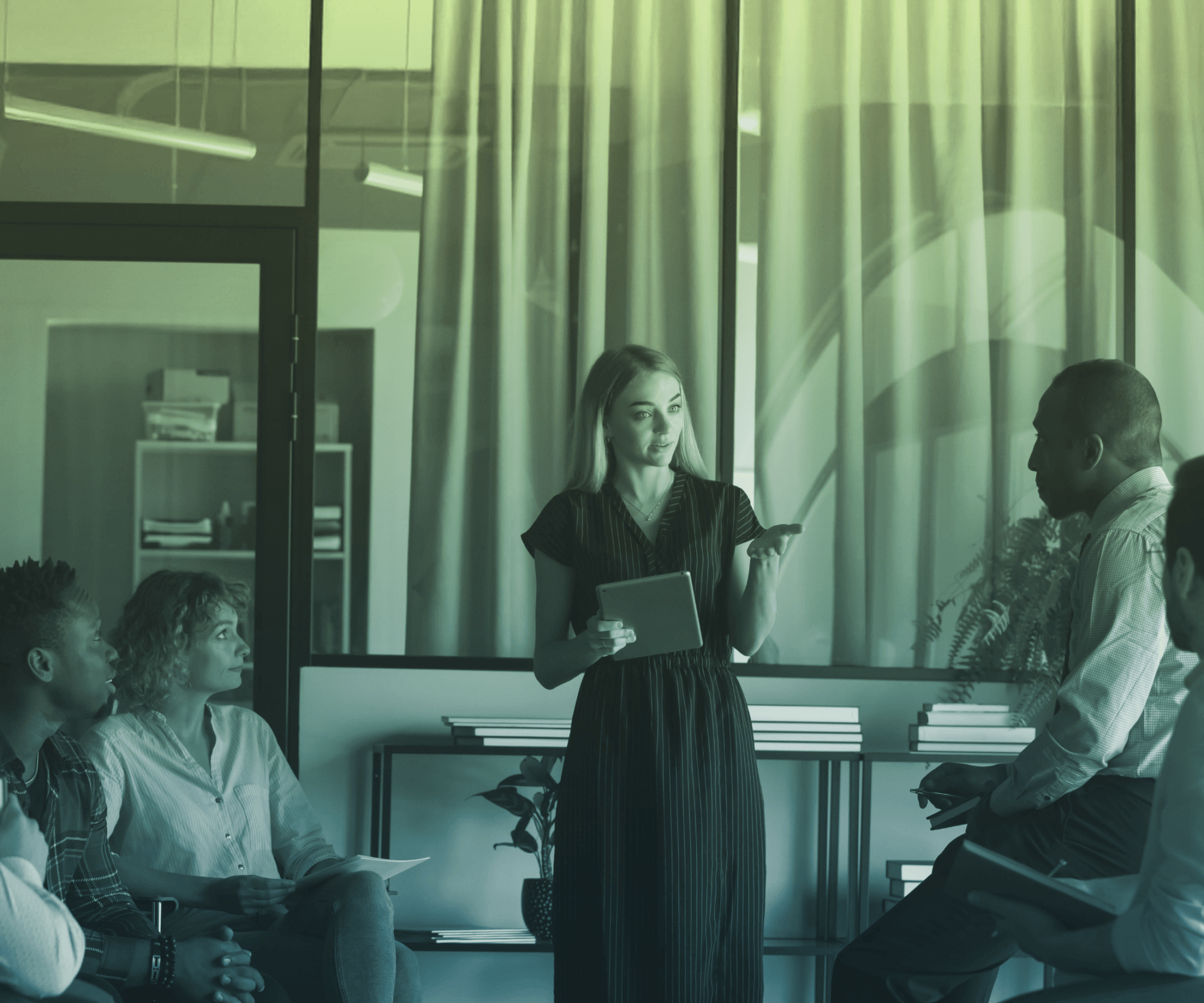 A presenter in front of a group of people.